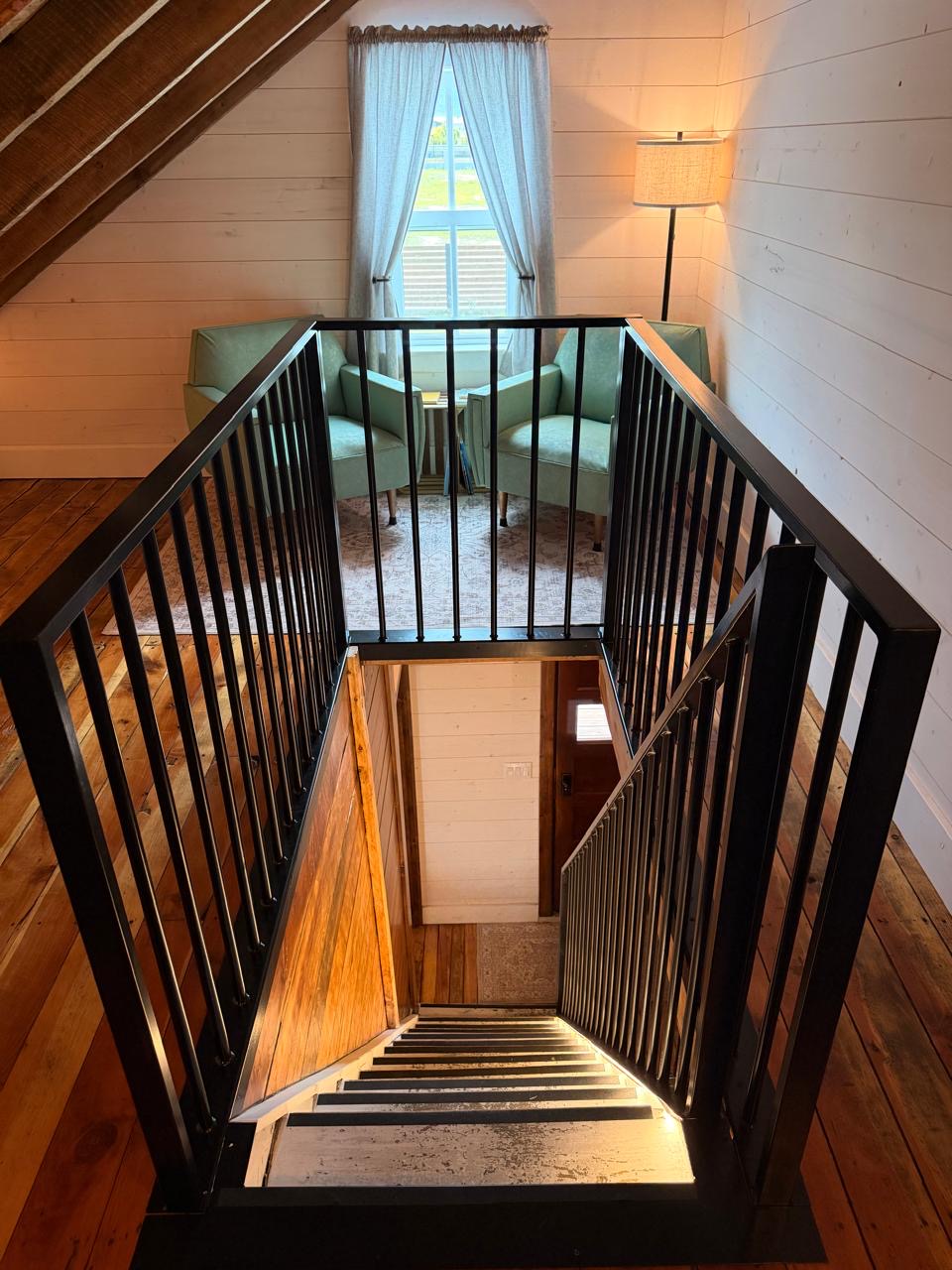 View down the loft stairwell to the seating area and window