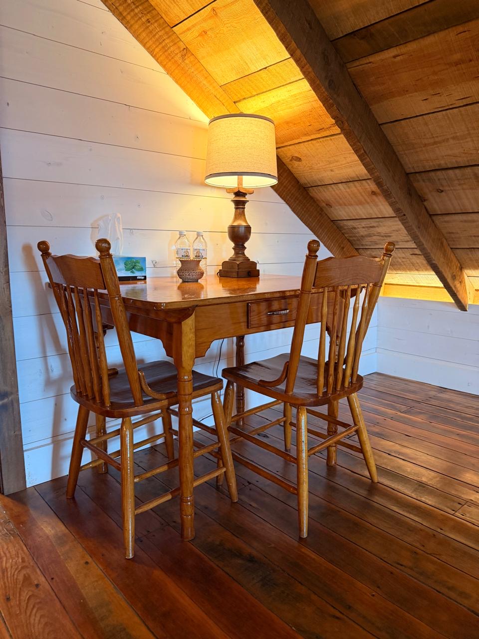 Breakfast nook with an antique drop-leaf table and spindle-back chairs