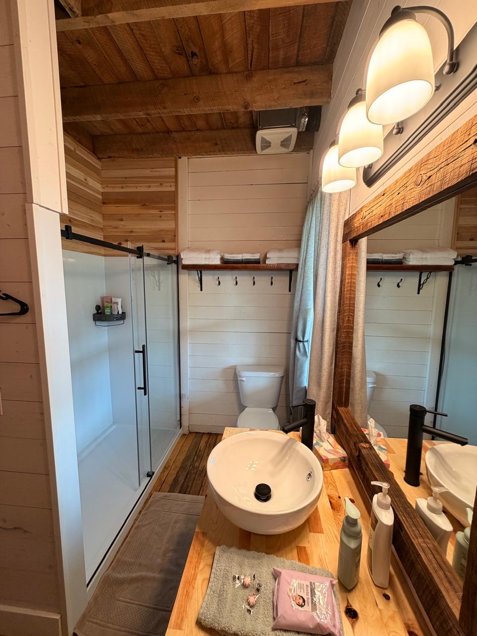 Bathroom with a glass walk-in shower and a vessel sink on butcher block