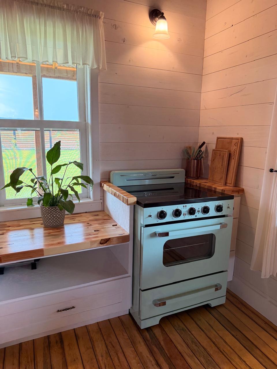 Kitchen corner with a retro mint-green range and butcher-block counters