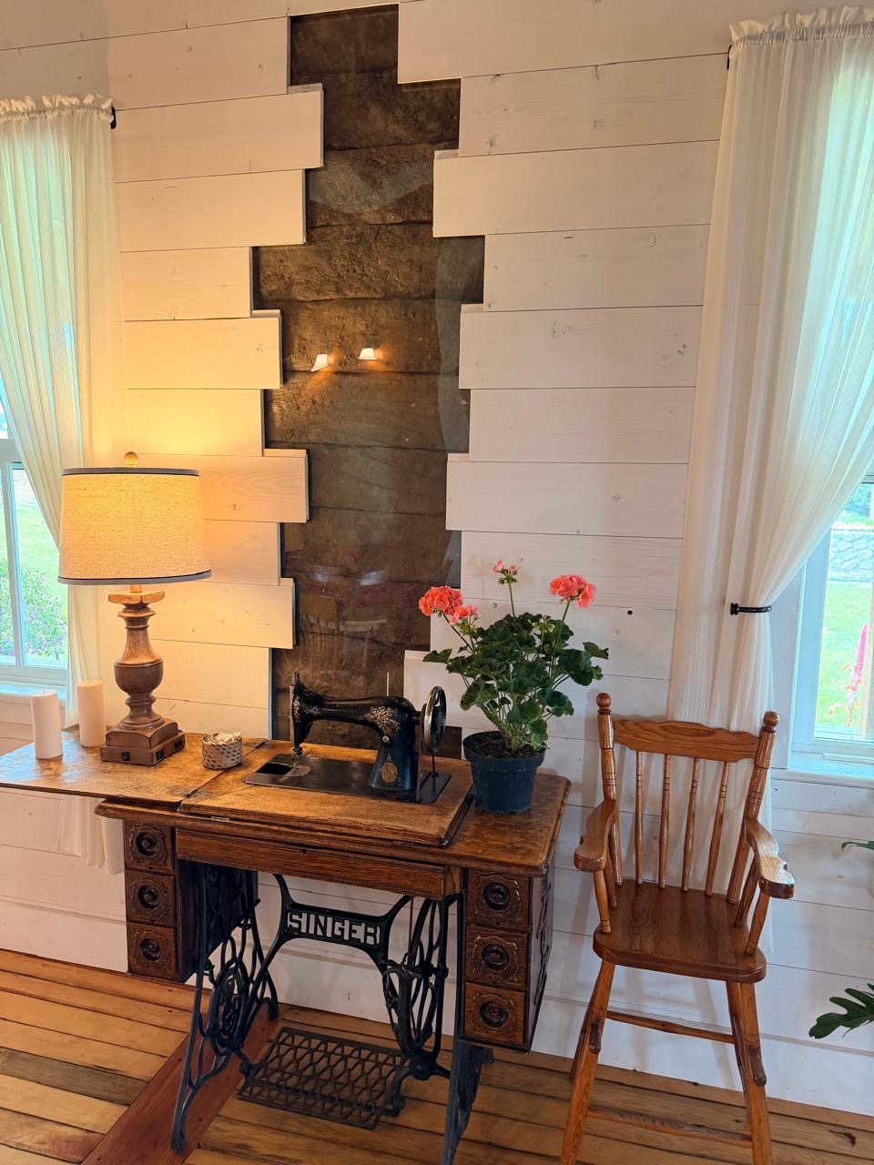 Antique Singer treadle sewing machine against a section of the original adobe wall