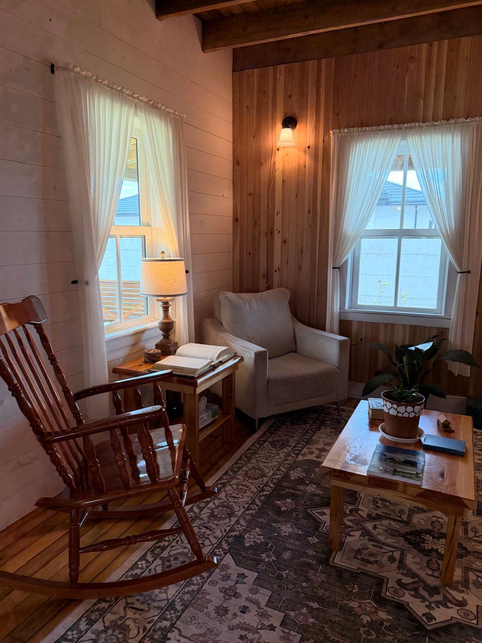 Quiet corner with a wooden rocking chair, armchair and an open book